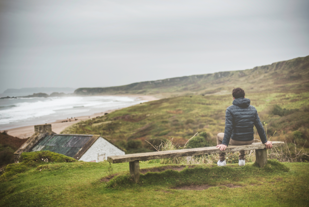 Man Sitting On Bench , Rear View ,enjoying Oceanic Coast View