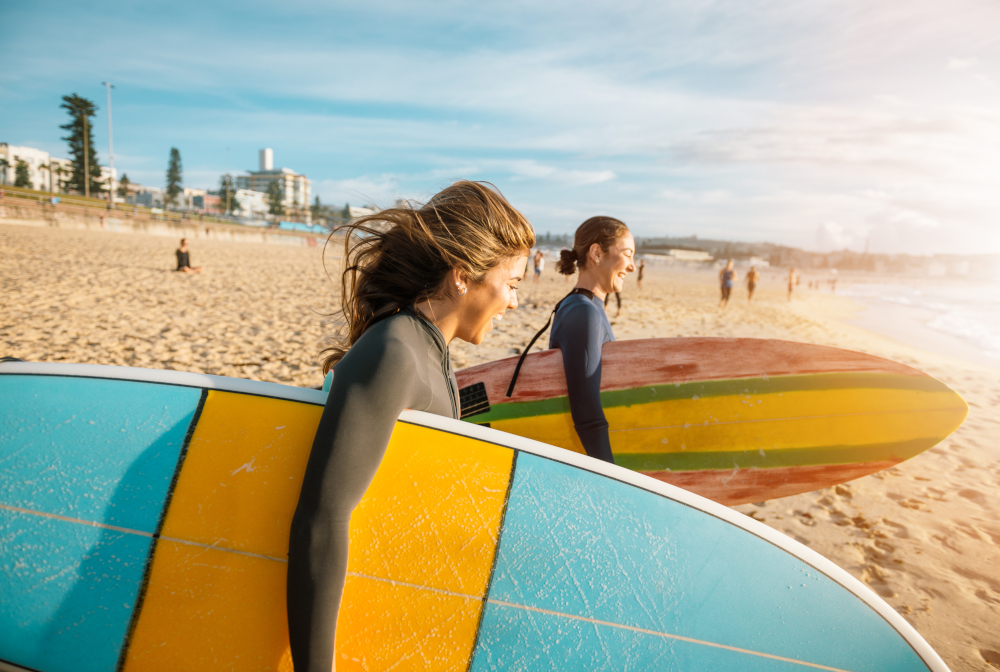 Female Surfers Rushing To Catch A Waves