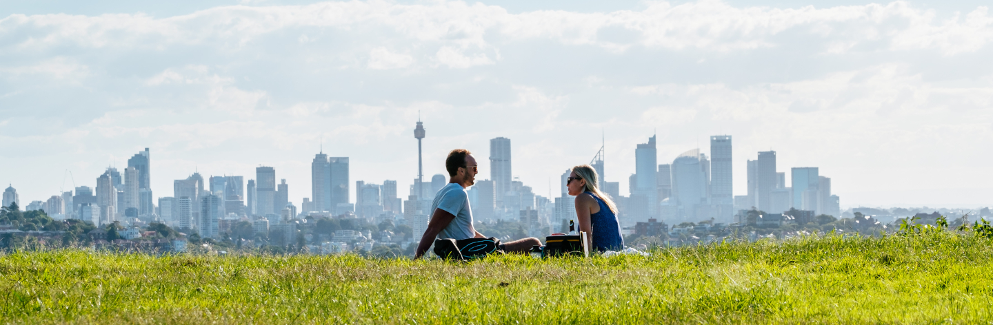 Couple Sitting On Field