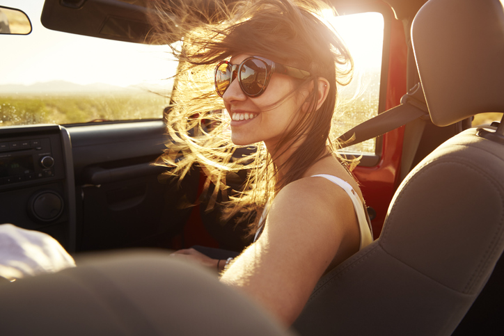 Woman Passenger On Road Trip In Convertible Car