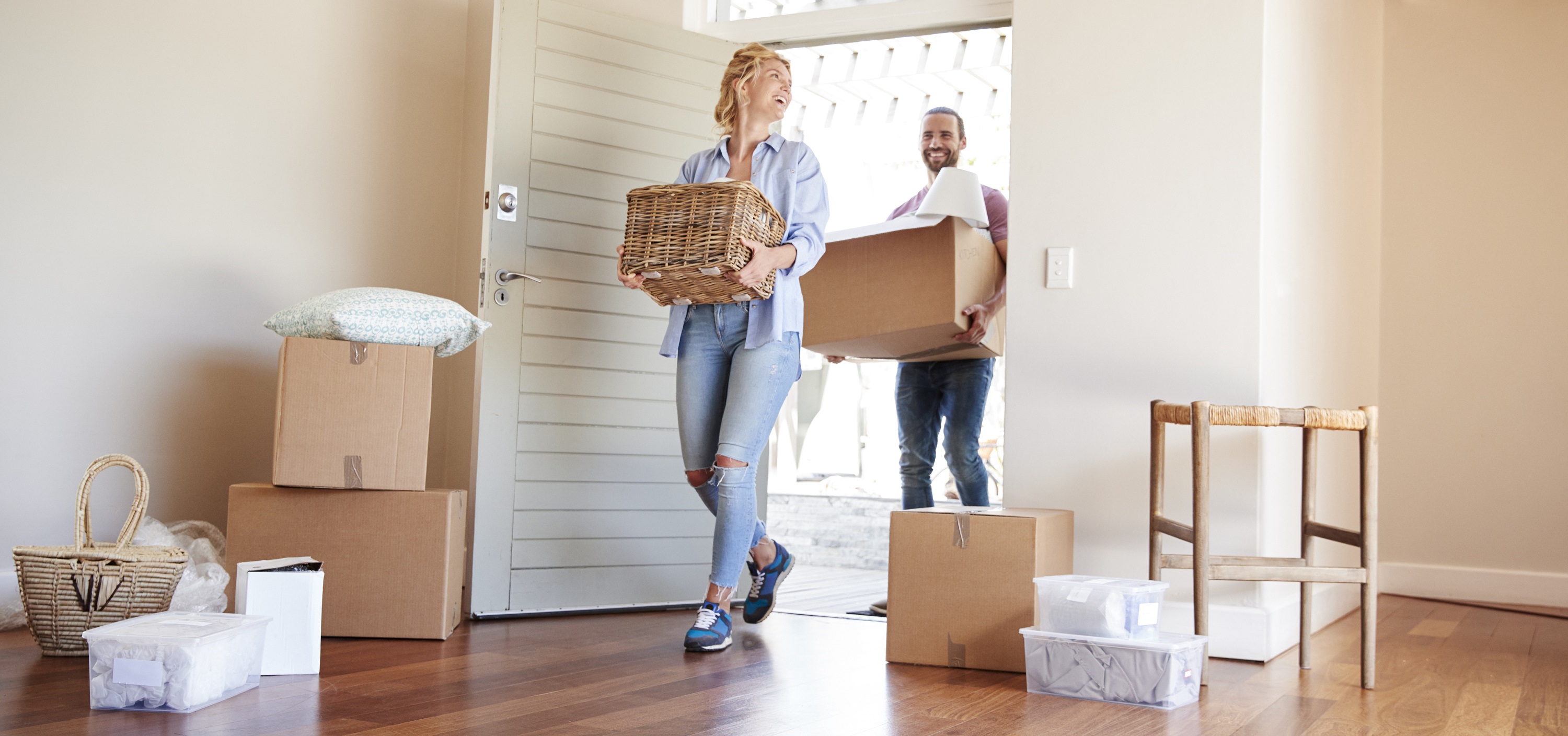 Couple Carrying Boxes Into New Home On Moving Day