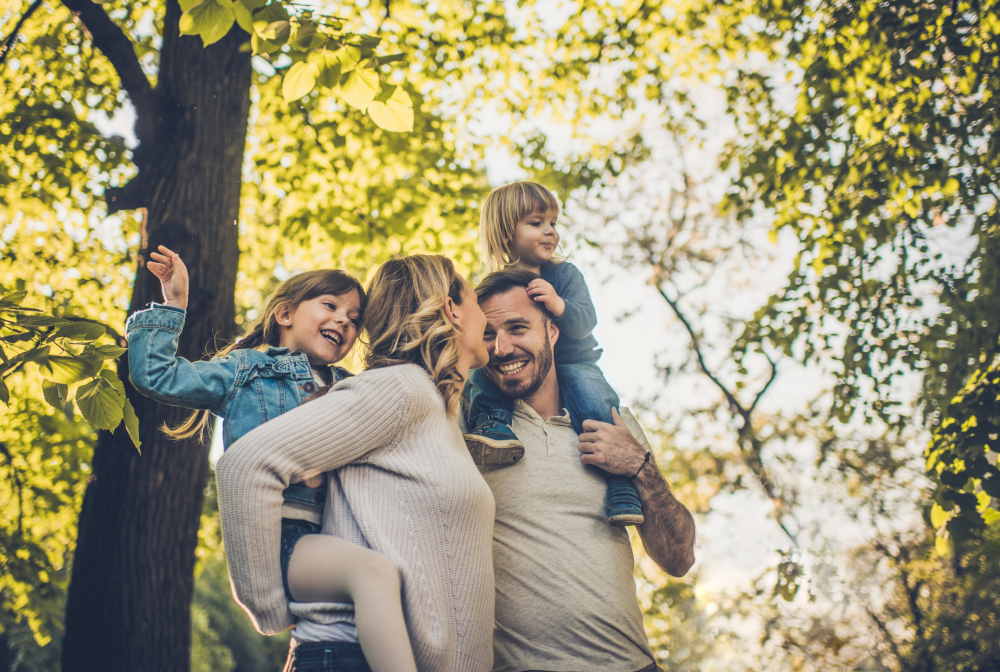 Below View Of Carefree Family Having Fun In Spring Day.