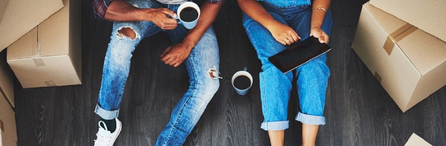 High Angle Shot Of An Unrecognizable Couple Using A Tablet In Their New Home