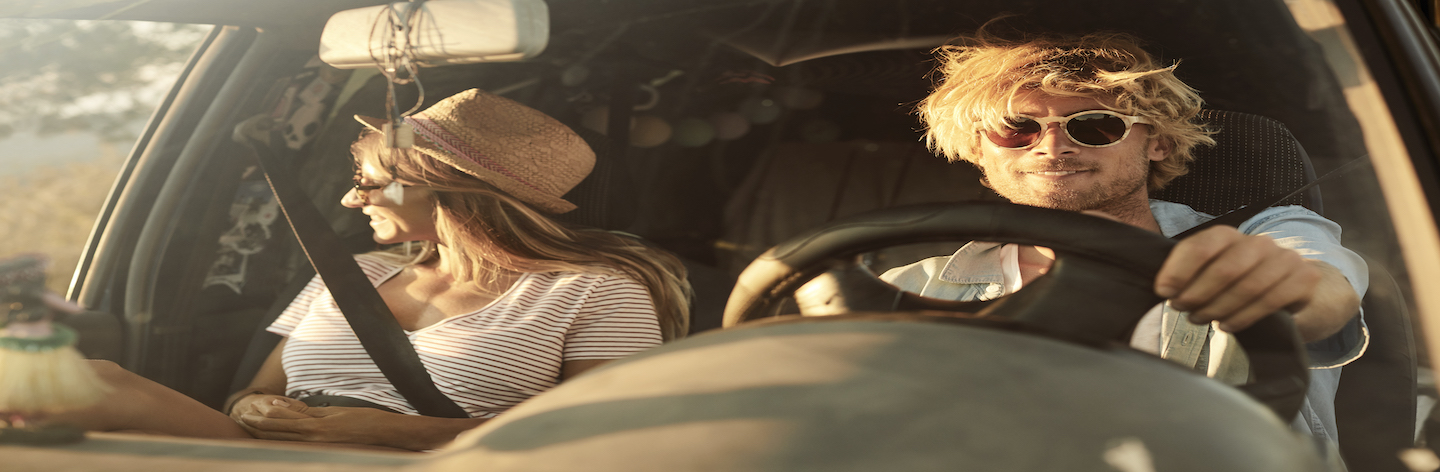 Man With Girlfriend Driving Car During Road Trip