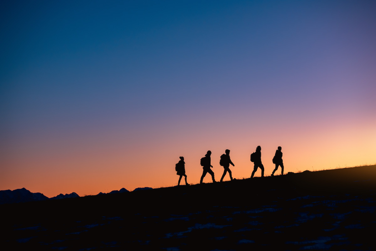 Group Of Hikers At Sunset Mountain