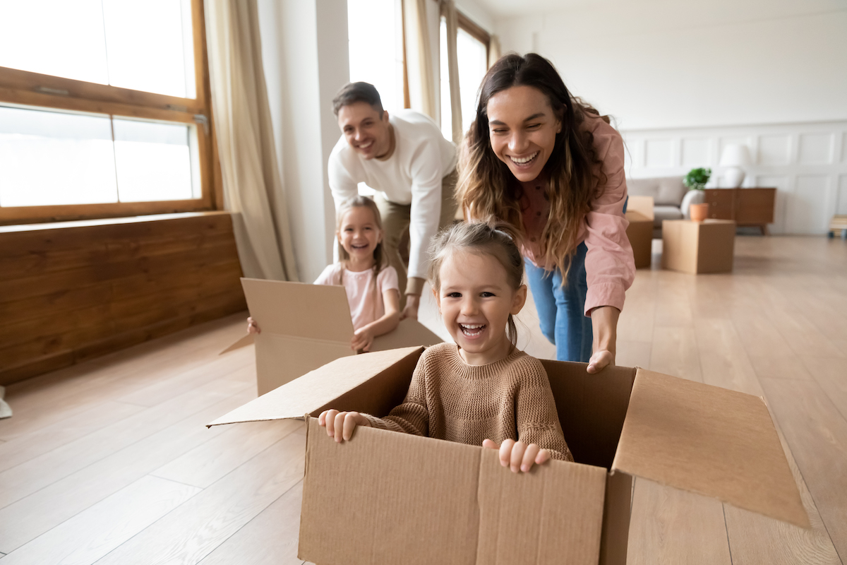 http://Happy%20Parents%20Playing%20With%20Little%20Kids%20Riding%20In%20Box