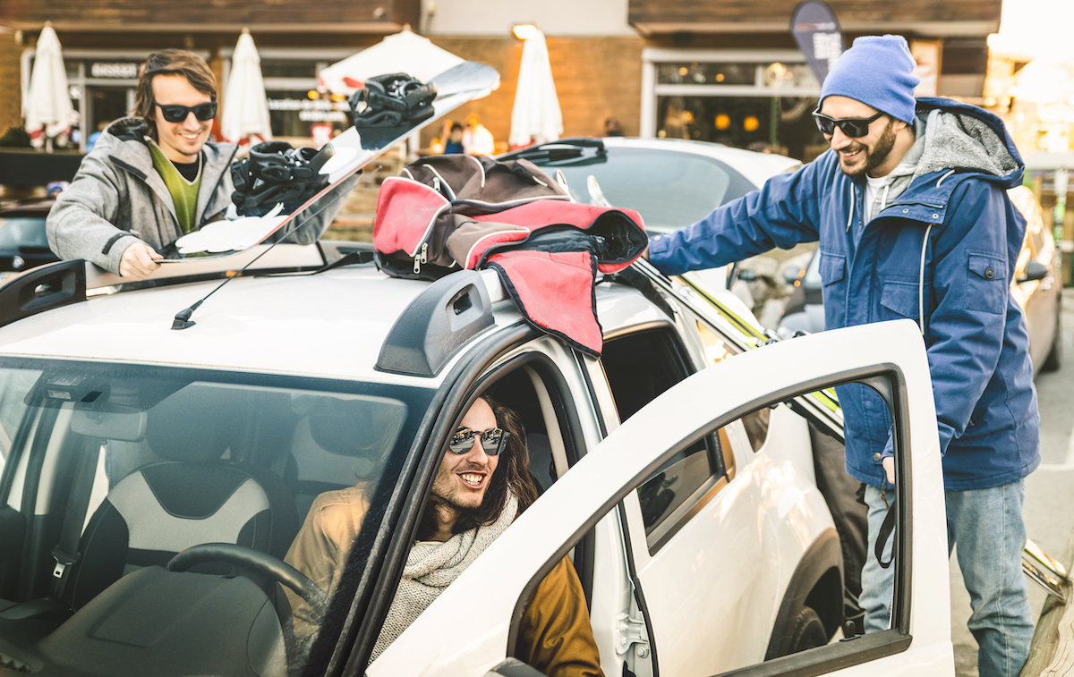 Best Friends Having Fun Together Preparing Car For Ski And Snowboard At Mountain Trip Friendship Hangout Concept With Young People Loving Winter Sports Travel Vintage Desaturated Contrast Filter